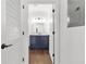 Bathroom view through doorway, showcasing blue vanity with marble countertop and modern fixtures at 2277 Peachtree Ne Rd # 405, Atlanta, GA 30309