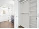 Bright bathroom and closet featuring a shower over bath, modern fixtures, and ample storage shelves at 2277 Peachtree Ne Rd # 405, Atlanta, GA 30309