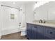 Updated bathroom with a navy vanity, marble countertop, modern fixtures, and a tiled shower over bath at 2277 Peachtree Ne Rd # 405, Atlanta, GA 30309