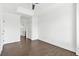 Bright bedroom with hardwood floors, white walls, ceiling fan, and doorways to a bathroom and closet at 2277 Peachtree Ne Rd # 405, Atlanta, GA 30309