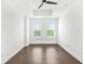 Bedroom with two windows and wood-look flooring, bright white walls, ceiling fan, and recessed lighting at 2277 Peachtree Ne Rd # 405, Atlanta, GA 30309