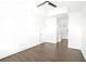Bright bedroom with hardwood floors, white walls, ceiling fan, and doorways to a bathroom and closet at 2277 Peachtree Ne Rd # 405, Atlanta, GA 30309
