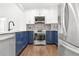 Modern kitchen with stainless steel appliances and stylish blue cabinetry at 2277 Peachtree Ne Rd # 405, Atlanta, GA 30309