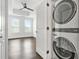 Laundry room showcasing stacked washer and dryer, with view of a bright bedroom through the open door at 2277 Peachtree Ne Rd # 405, Atlanta, GA 30309