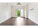 Bright living room featuring hardwood floors, white walls, ceiling fan, and french doors opening to a balcony at 2277 Peachtree Ne Rd # 405, Atlanta, GA 30309