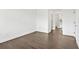 Bright living room featuring hardwood floors, white walls, and doorway to a bathroom at 2277 Peachtree Ne Rd # 405, Atlanta, GA 30309