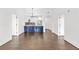 Open-concept living room with sleek wood floors and modern kitchen in background at 2277 Peachtree Ne Rd # 405, Atlanta, GA 30309