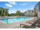 Refreshing outdoor pool with lounge chairs, umbrellas, and a beautiful view of the city skyline at 2277 Peachtree Ne Rd # 405, Atlanta, GA 30309