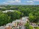 Scenic aerial view of brick apartments surrounded by lush greenery and mature trees on a sunny day at 50 Mount Vernon Cir, Atlanta, GA 30338