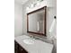 Bathroom featuring granite countertop, elegant wood framed mirror, and bright vanity lighting at 50 Mount Vernon Cir, Atlanta, GA 30338