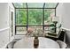 Sunlit dining area featuring skylight, modern furniture, and serene backyard view at 50 Mount Vernon Cir, Atlanta, GA 30338