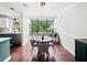 Bright dining area with glass ceiling, round table and backyard view at 50 Mount Vernon Cir, Atlanta, GA 30338