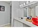 Bright bathroom with a white vanity, framed mirror, and walk-in shower with coordinated gray wall color at 830 Bonnie Glen Se Dr, Marietta, GA 30067