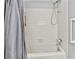 Bathroom with a white tiled shower and tub with a grey shower curtain at 830 Bonnie Glen Se Dr, Marietta, GA 30067