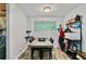 Dining area with a modern table set, sleek chairs, and a functional storage rack at 830 Bonnie Glen Se Dr, Marietta, GA 30067