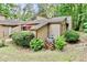 Charming exterior view of home with manicured lawn, colorful foliage and a patio with red umbrella at 830 Bonnie Glen Se Dr, Marietta, GA 30067