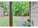 View from the front porch to a landscaped walkway surrounded by trees at 830 Bonnie Glen Se Dr, Marietta, GA 30067