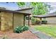 Cozy home with a stone facade, wood siding, manicured landscaping, and a welcoming walkway at 830 Bonnie Glen Se Dr, Marietta, GA 30067