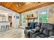 Cozy living room boasts a stone fireplace, wood ceiling, and plush, reclining seating at 830 Bonnie Glen Se Dr, Marietta, GA 30067