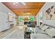 Spacious living room with a wood ceiling, stone fireplace, and an inviting grey sectional sofa at 830 Bonnie Glen Se Dr, Marietta, GA 30067