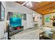 Well-lit living room with a TV, wood ceiling, stone fireplace, and an open bar counter at 830 Bonnie Glen Se Dr, Marietta, GA 30067