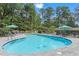 Community pool area surrounded by trees, with lounge chairs and tables for residents' enjoyment at 830 Bonnie Glen Se Dr, Marietta, GA 30067