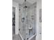 Modern bathroom featuring a tiled shower with glass door and stylish fixtures at 230 Sheringham Dr, Roswell, GA 30076