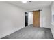 Clean bedroom with a light carpet, and sliding barn door for closet access at 230 Sheringham Dr, Roswell, GA 30076