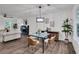 Elegant dining area with a glass-top table, comfortable seating, and a view of the living space, perfect for intimate gatherings at 230 Sheringham Dr, Roswell, GA 30076