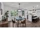 Modern dining area with a sleek table, stylish chairs, and an open view to the kitchen, ideal for casual dining and entertaining at 230 Sheringham Dr, Roswell, GA 30076