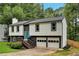 Charming two-story home with a beautifully landscaped front yard, a blue front door, and an attached two-car garage at 230 Sheringham Dr, Roswell, GA 30076