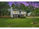 Inviting home with a spacious front yard, manicured lawn, and a quaint deck, perfect for outdoor enjoyment and relaxation at 230 Sheringham Dr, Roswell, GA 30076