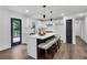 Modern kitchen with bar stool seating at island, white cabinets, and stainless steel appliances at 230 Sheringham Dr, Roswell, GA 30076