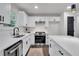 Well-appointed kitchen featuring white cabinetry, modern appliances, and sleek finishes, creating a clean and efficient workspace at 230 Sheringham Dr, Roswell, GA 30076