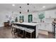 Contemporary kitchen featuring white cabinets, quartz countertops, and an island with seating, offering style and functionality at 230 Sheringham Dr, Roswell, GA 30076