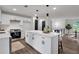 Bright kitchen features a large island, stainless steel appliances, and modern white cabinets at 230 Sheringham Dr, Roswell, GA 30076