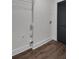 Minimalist laundry room with shelving and white walls next to a door with horizontal blinds at 230 Sheringham Dr, Roswell, GA 30076