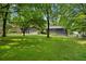 Expansive backyard with verdant lawn and shade trees providing ample space and a peaceful outdoor environment at 2661 Fleur De Lis Pl, Atlanta, GA 30360