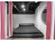 Bedroom in an unfinished basement with a black platform bed and accent curtains at 2661 Fleur De Lis Pl, Atlanta, GA 30360