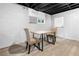 Basement with painted walls, black ceiling and flooring with a small table and two upholstered chairs at 2661 Fleur De Lis Pl, Atlanta, GA 30360