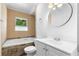 Bright bathroom featuring a soaking tub, neutral tile, and white vanity at 2661 Fleur De Lis Pl, Atlanta, GA 30360