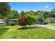 A charming house with a well-manicured lawn and mature trees at 2661 Fleur De Lis Pl, Atlanta, GA 30360