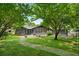 Charming home with a well-maintained front yard, mature trees and a welcoming pathway at 2661 Fleur De Lis Pl, Atlanta, GA 30360