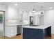 Bright kitchen featuring white cabinets, stainless steel appliances, and a navy blue kitchen island with marble countertop at 2661 Fleur De Lis Pl, Atlanta, GA 30360