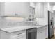 Close-up of the kitchen counter, marble backsplash, undermount sink and stainless steel appliances at 2661 Fleur De Lis Pl, Atlanta, GA 30360