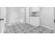 Bright laundry room with patterned tile flooring, modern white cabinets, and laundry sink at 2661 Fleur De Lis Pl, Atlanta, GA 30360