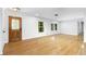 Living room featuring hardwood floors, large windows, and a stylish light fixture at 2661 Fleur De Lis Pl, Atlanta, GA 30360