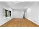 Bright living room with hardwood floors, large window, and white trim at 2661 Fleur De Lis Pl, Atlanta, GA 30360