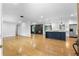 Open-concept living space with hardwood floors, updated kitchen, and modern fireplace at 2661 Fleur De Lis Pl, Atlanta, GA 30360