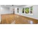Spacious living room with hardwood floors and windows overlooking mature trees at 2661 Fleur De Lis Pl, Atlanta, GA 30360